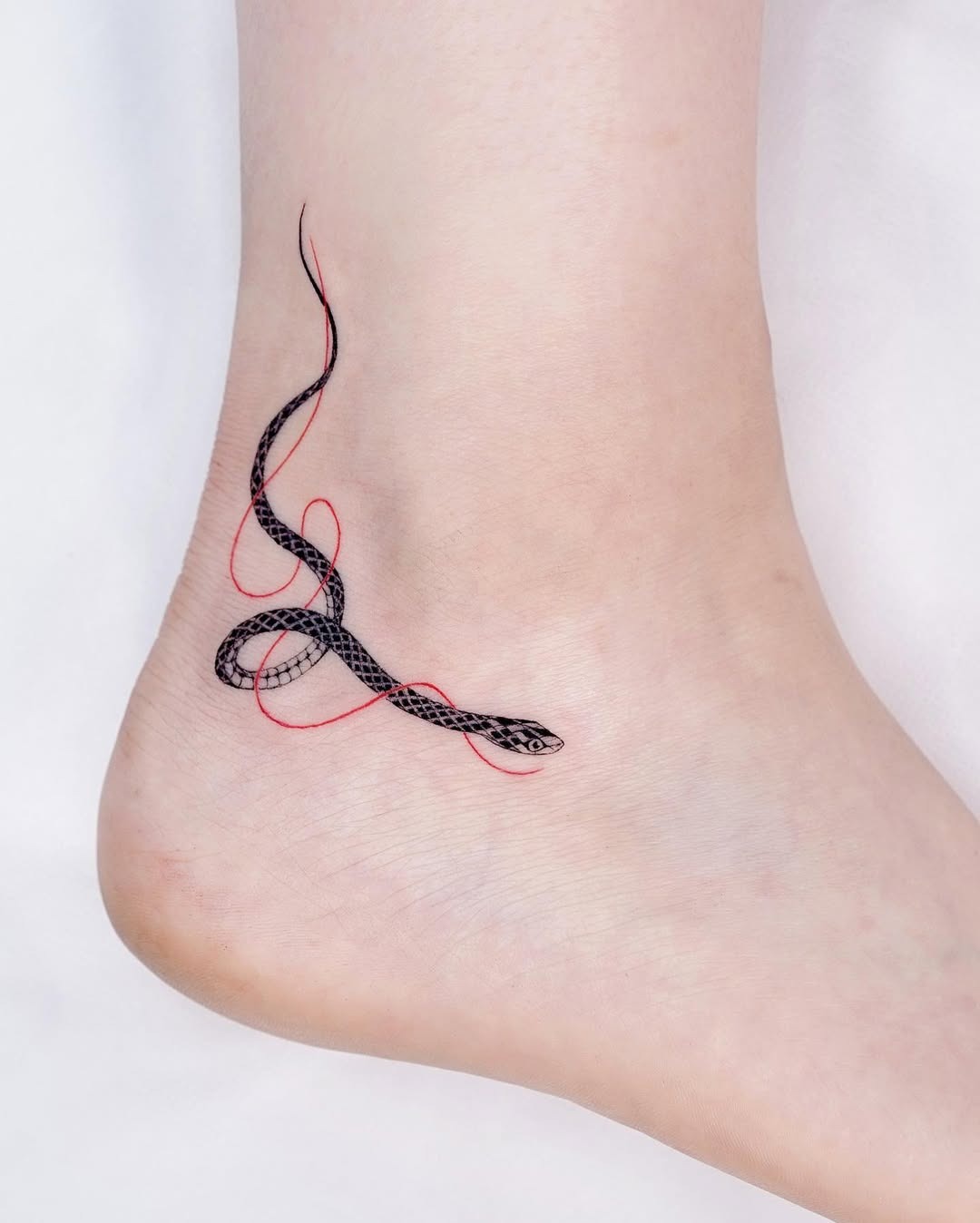 Elegant snake tattoo intertwining with bold lines Tattoo Design