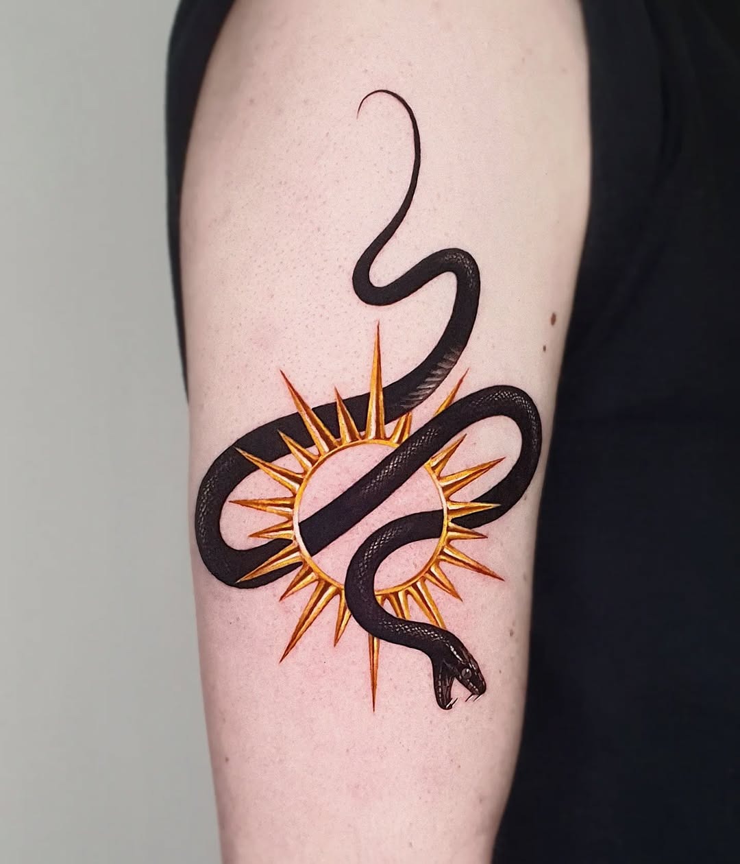 Elegant snake tattoo with sun motif Tattoo Design