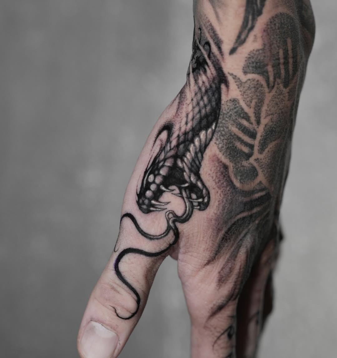 Intricate Black Snake Tattoo on Hand Tattoo Design