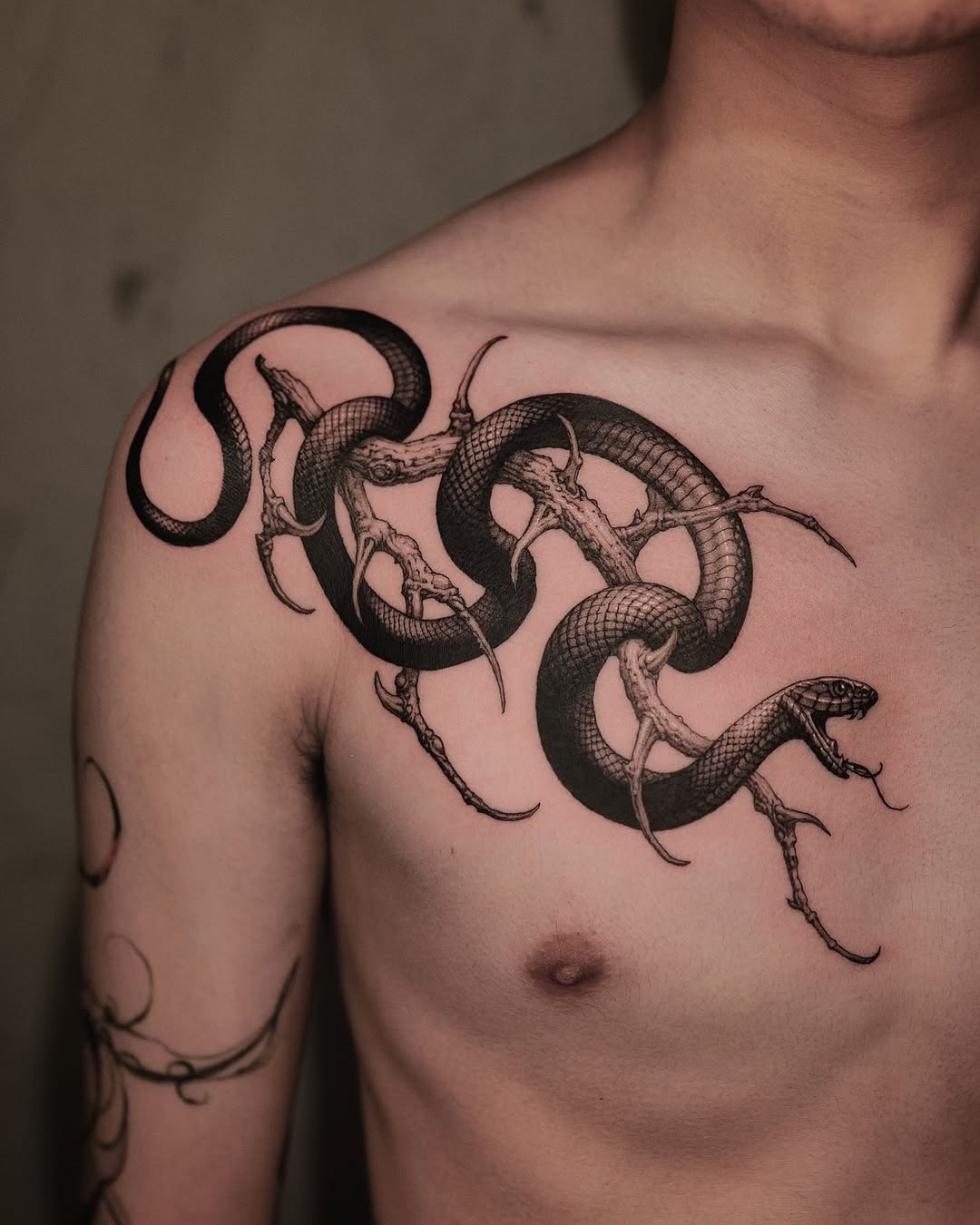 Intricate snake tattoo evolving on chest Tattoo Design