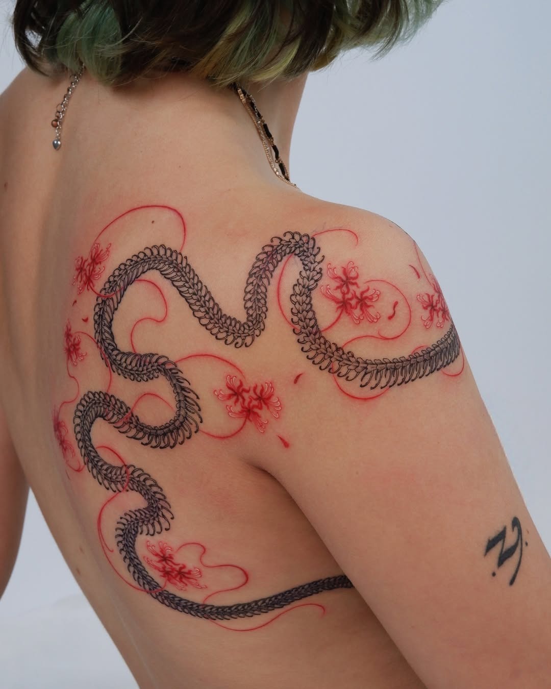 Intricate snake tattoo with floral elements Tattoo Design