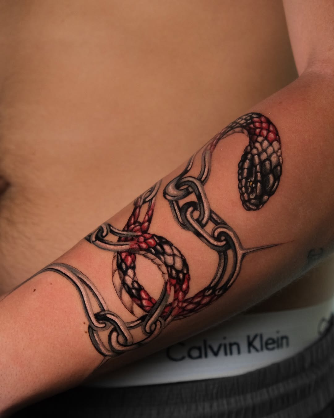 Intricate snake tattoo wrapped around forearm Tattoo Design