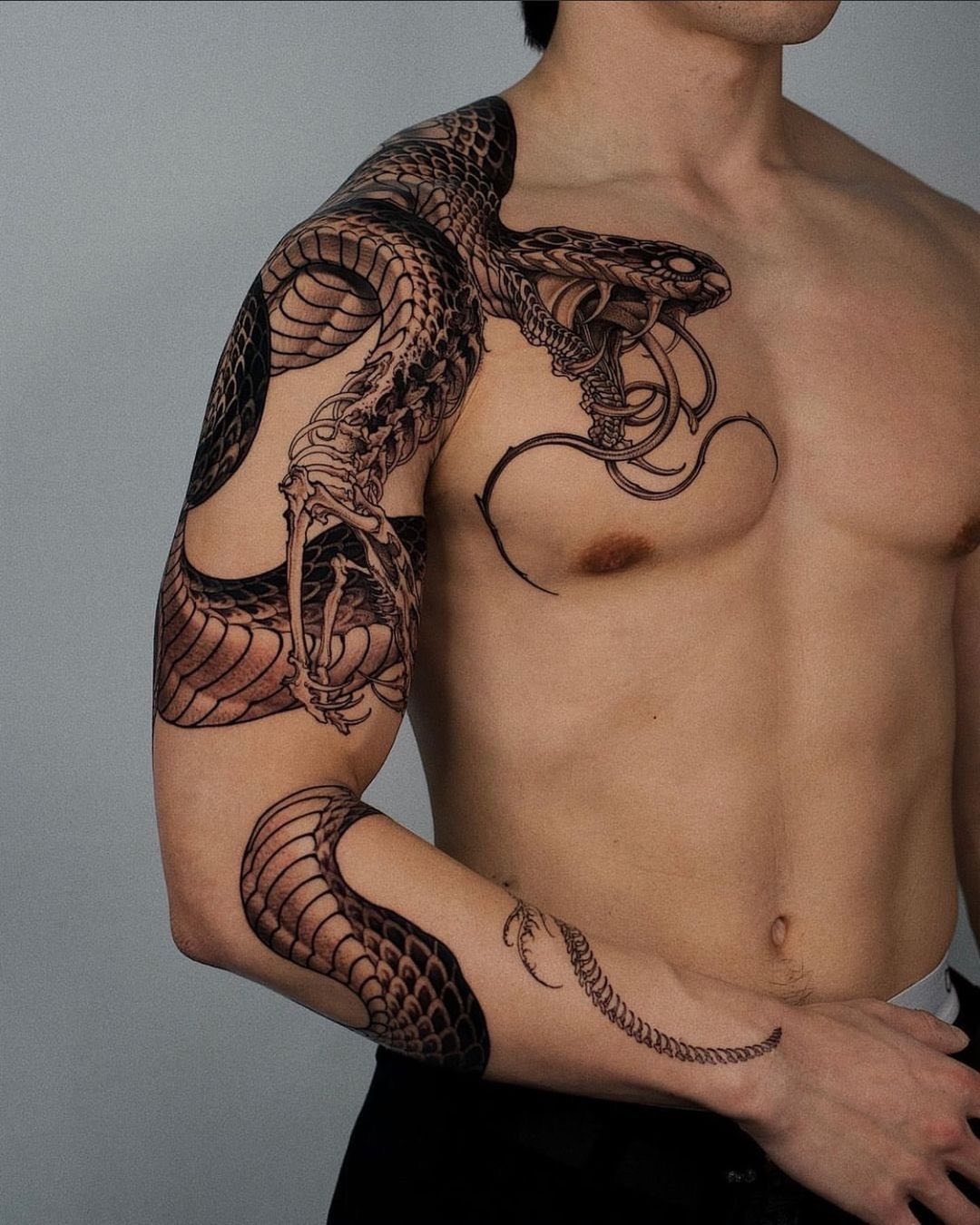 Intricate snake tattoo wrapping around the arm Tattoo Design