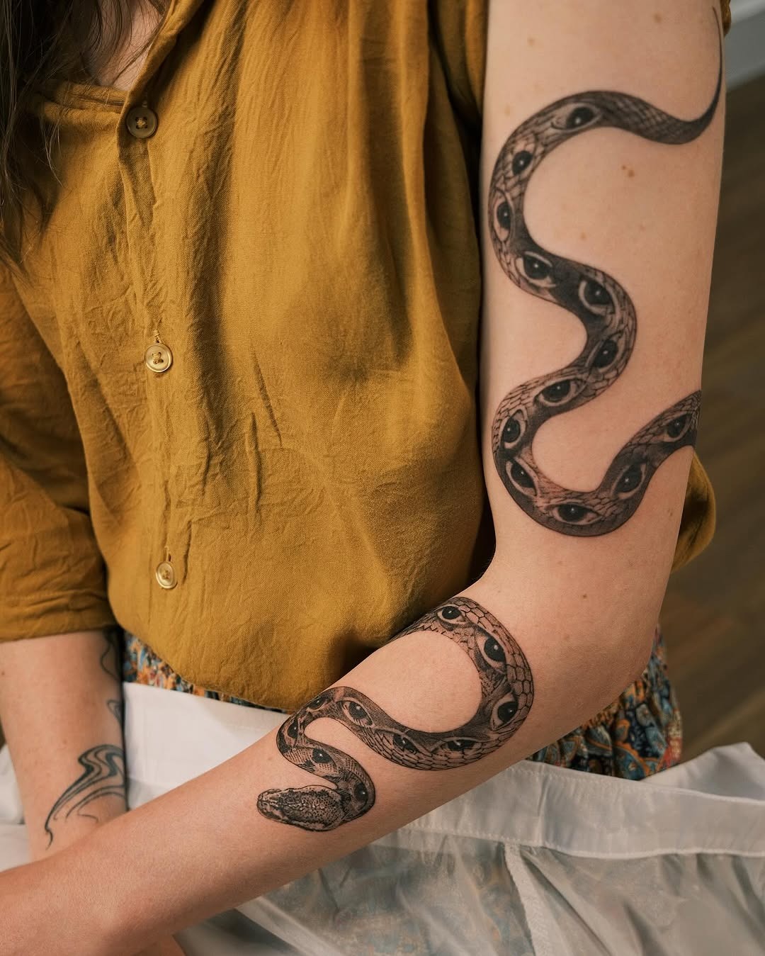 Intricate snake tattoo wrapping around the arm Tattoo Design