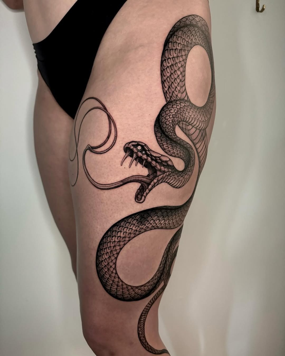 Intricate snake tattoo wrapping around the thigh Tattoo Design
