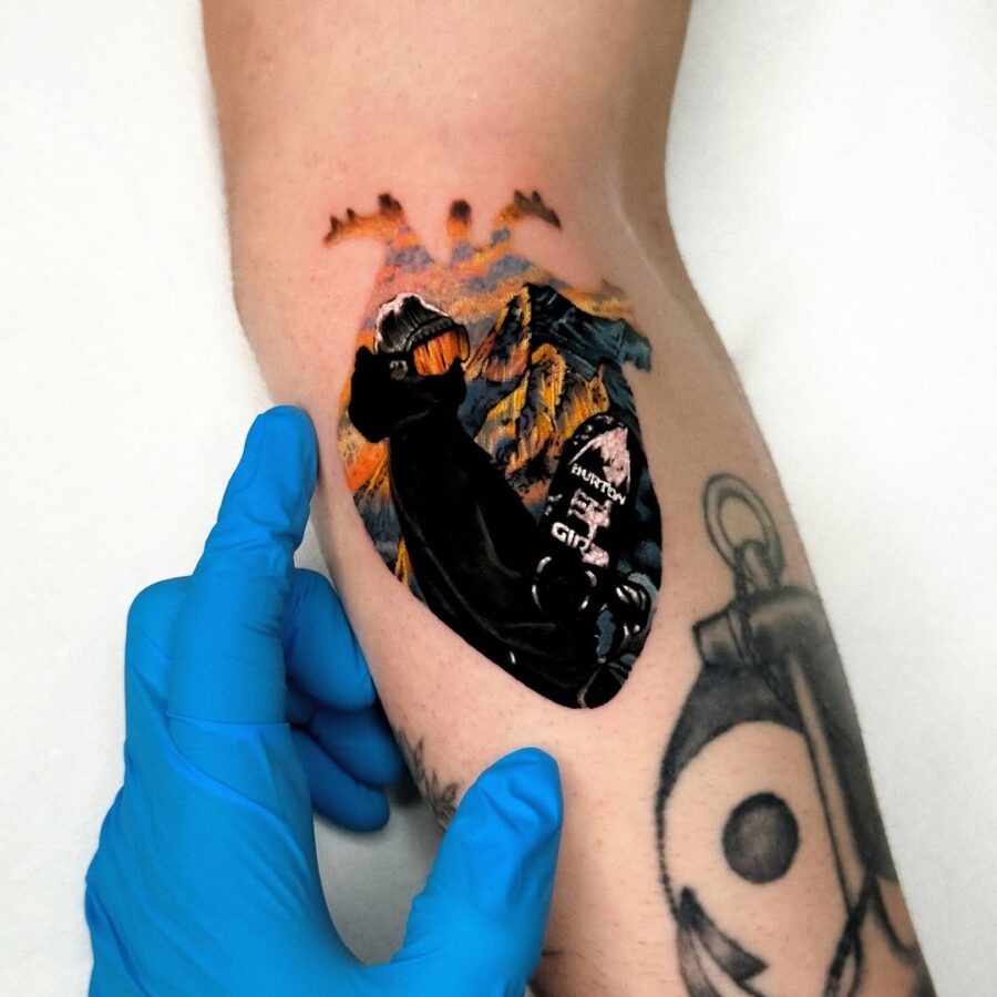 Vibrant snowboarder tattoo with mountain backdrop Tattoo Design