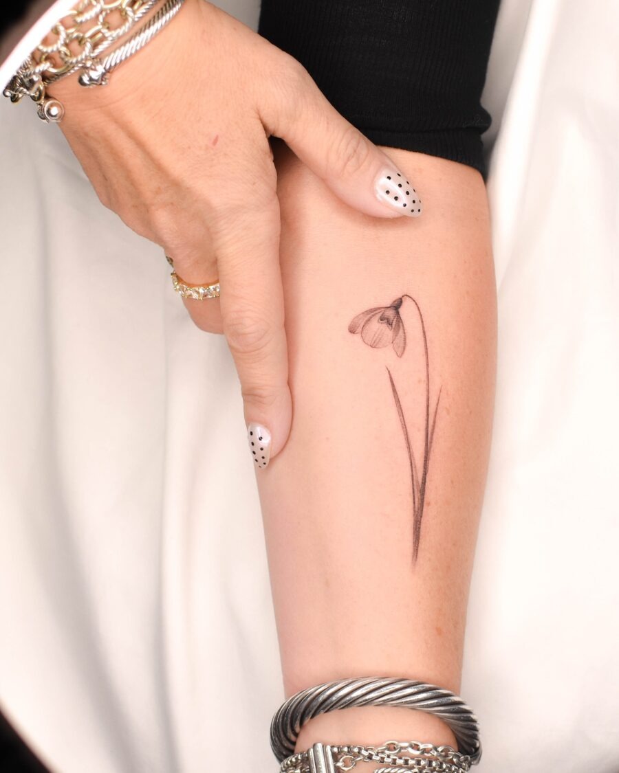 Elegant snowdrop flower tattoo on forearm Tattoo Design