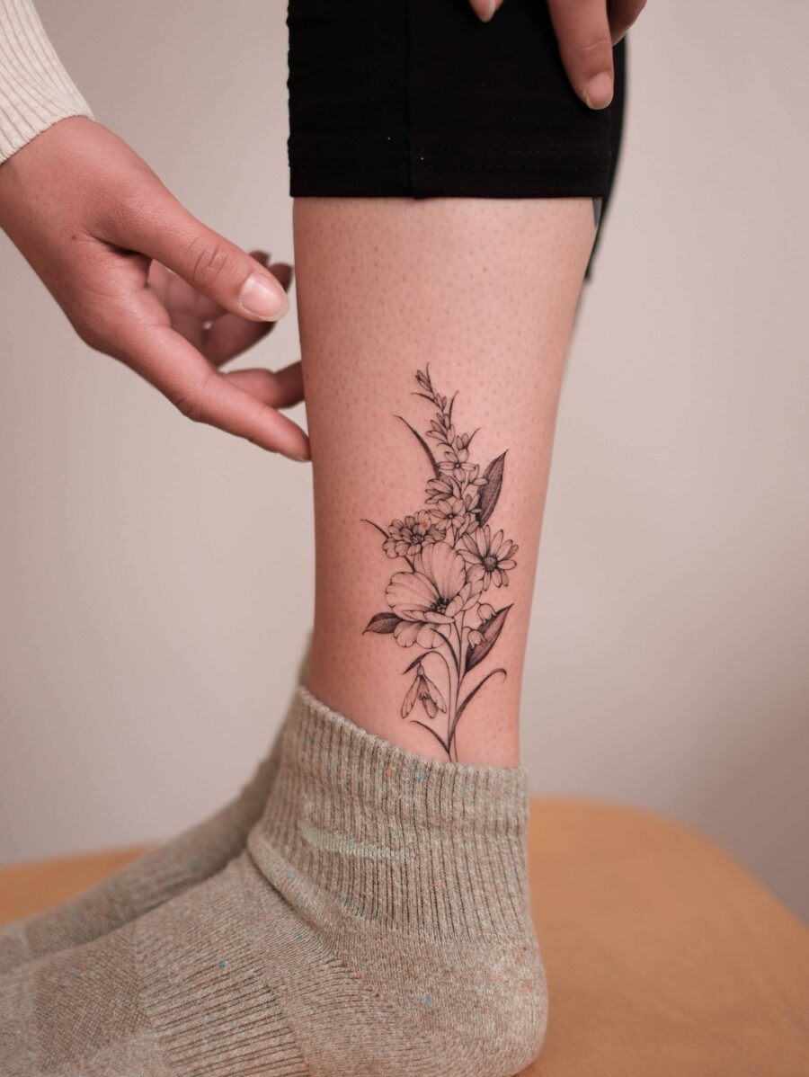 Elegant snowdrop flower tattoo on the leg Tattoo Design