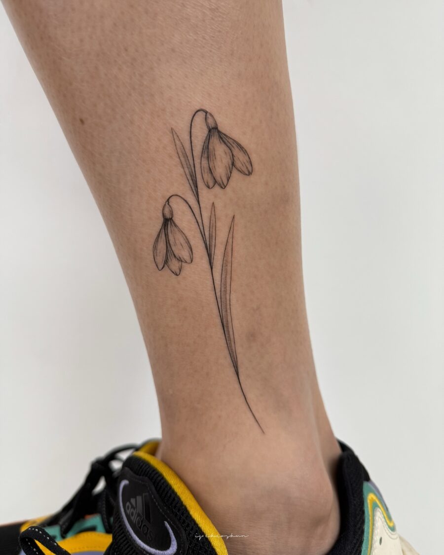 Elegant snowdrop tattoo adorned on the leg Tattoo Design