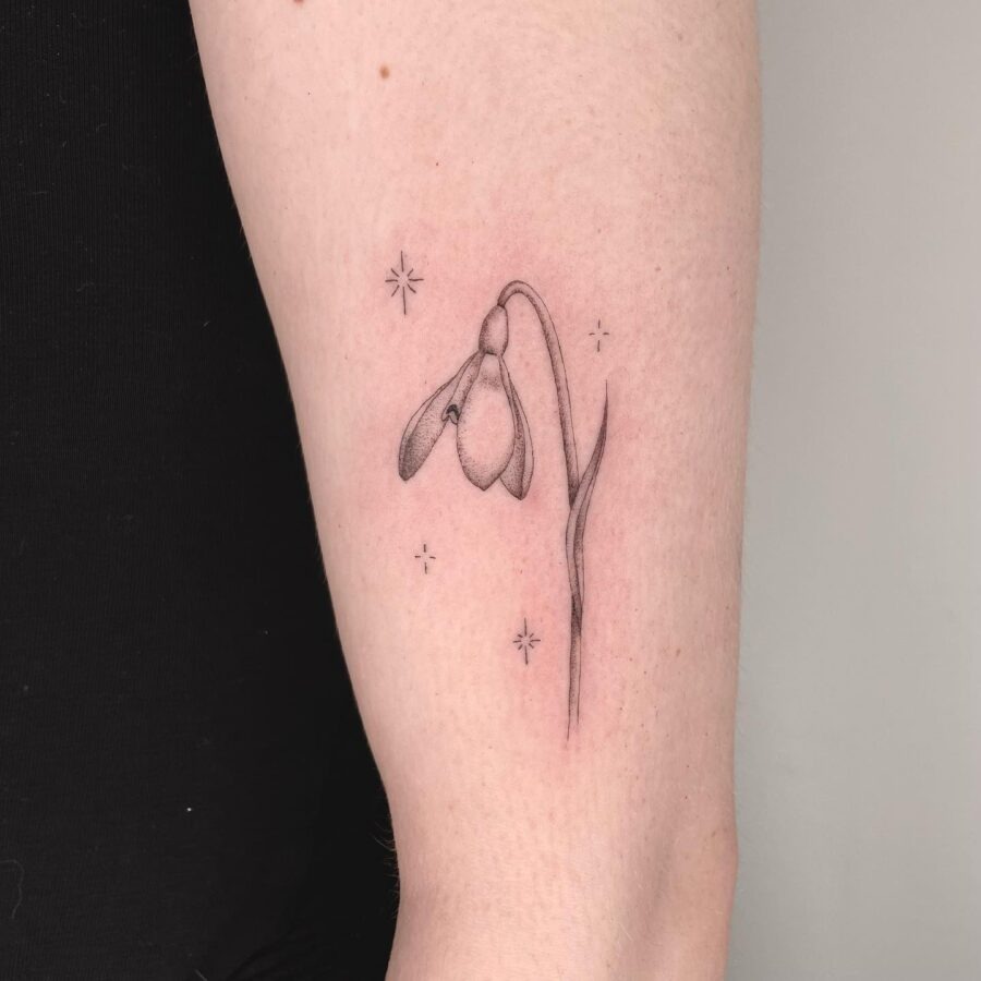 Elegant snowdrop tattoo with celestial accents Tattoo Design