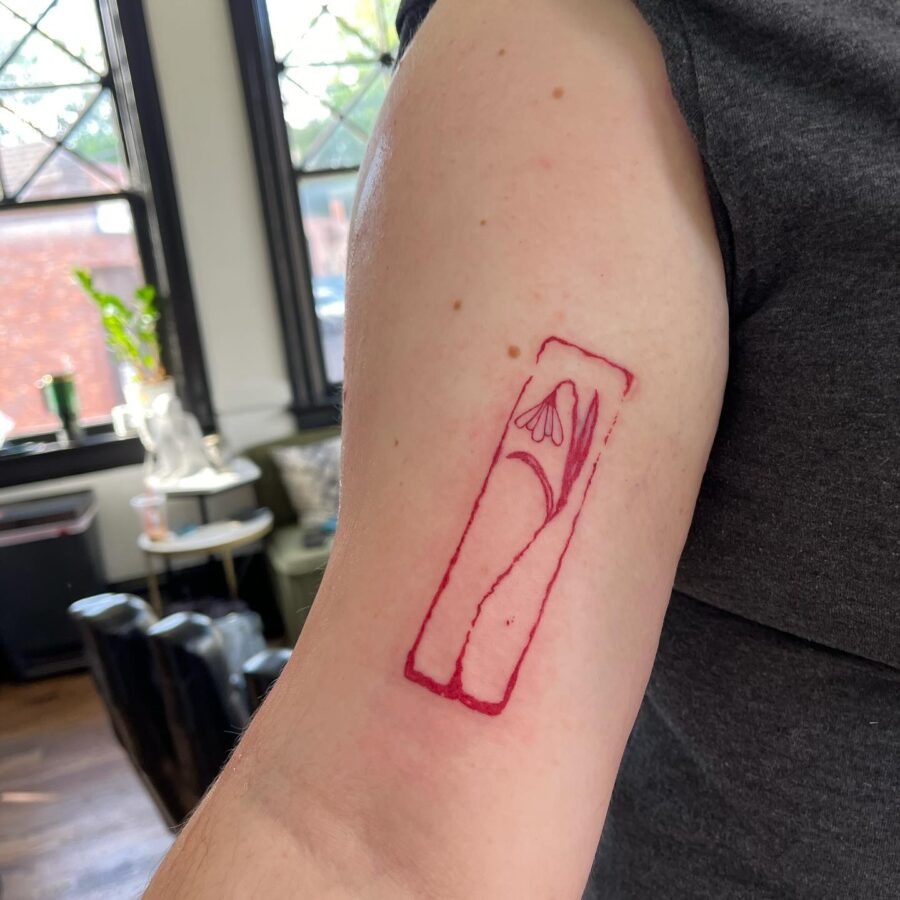 Minimalist snowdrop tattoo on arm. Tattoo Design