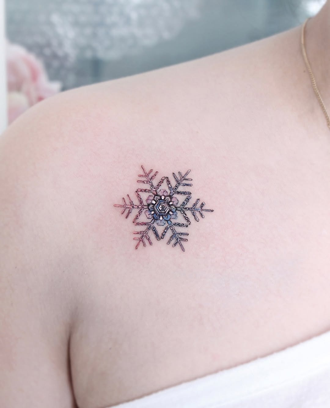 Delicate snowflake design with vibrant hues Tattoo Design