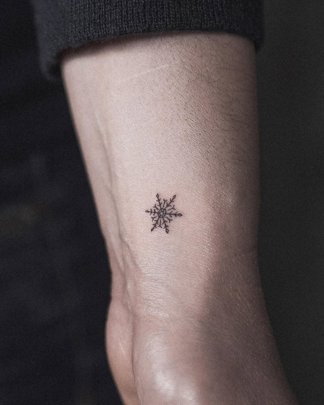 Elegant small snowflake tattoo on wrist Tattoo Design