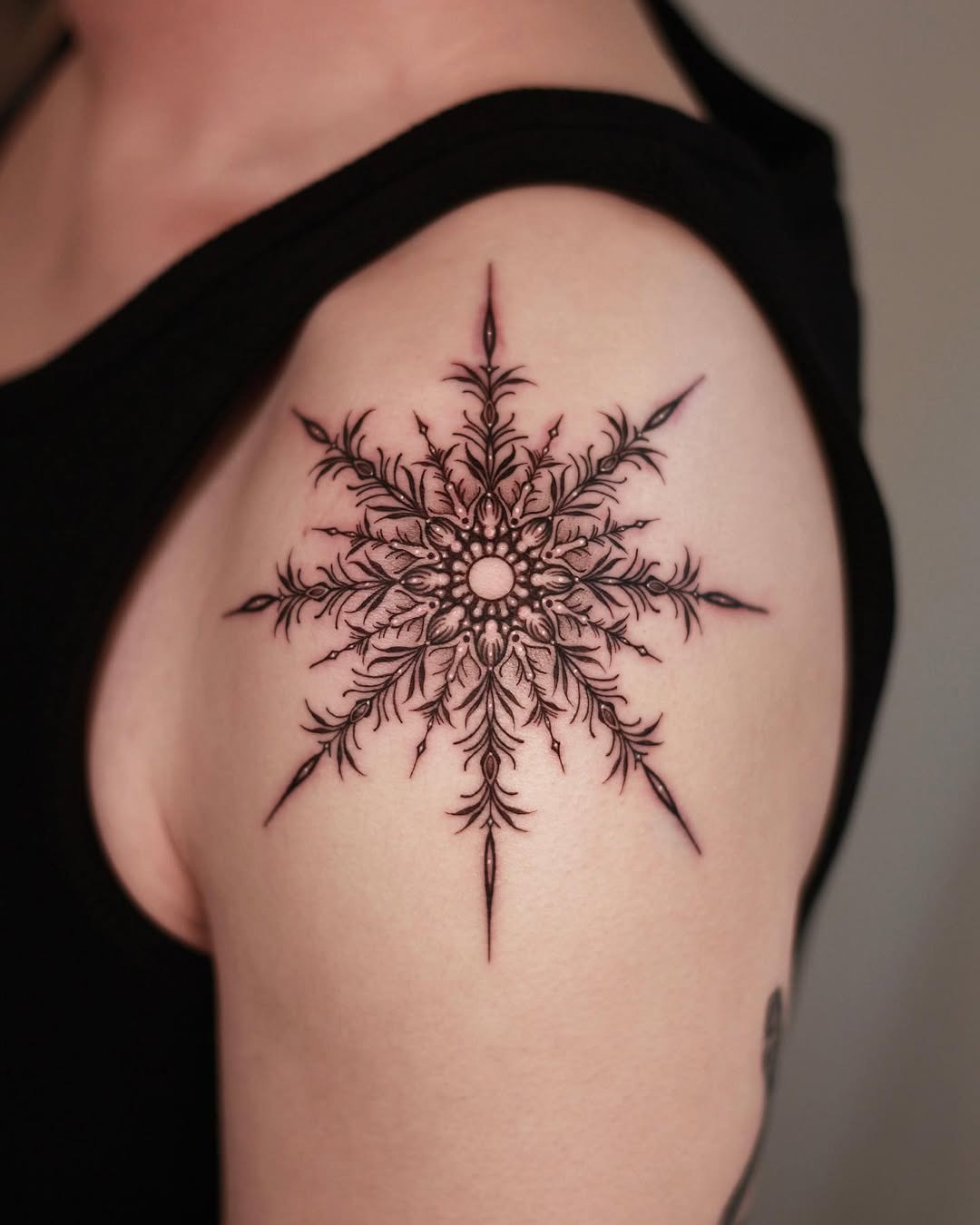 Intricate black ink snowflake tattoo design Tattoo Design