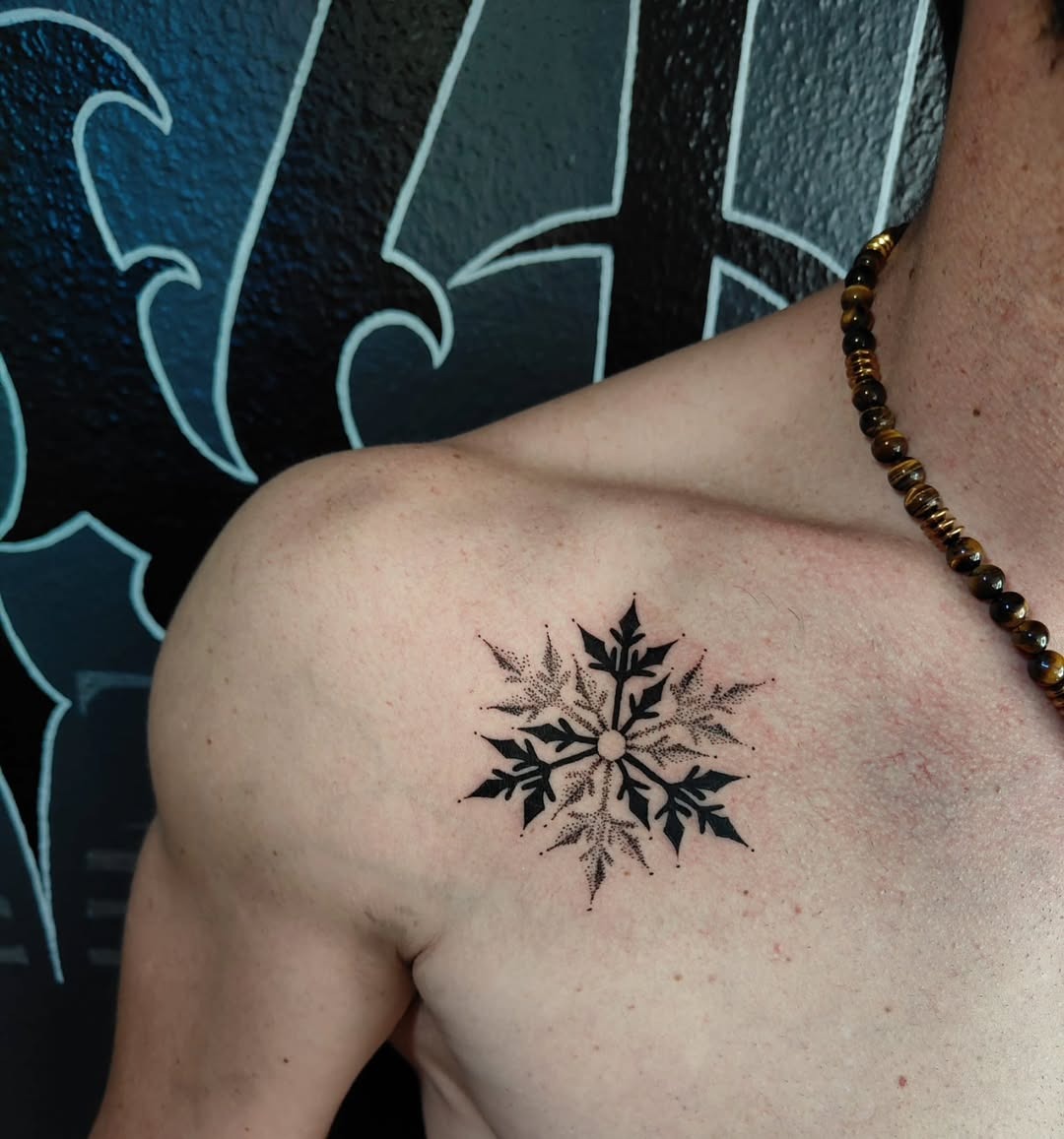 Intricate black ink snowflake tattoo on shoulder Tattoo Design