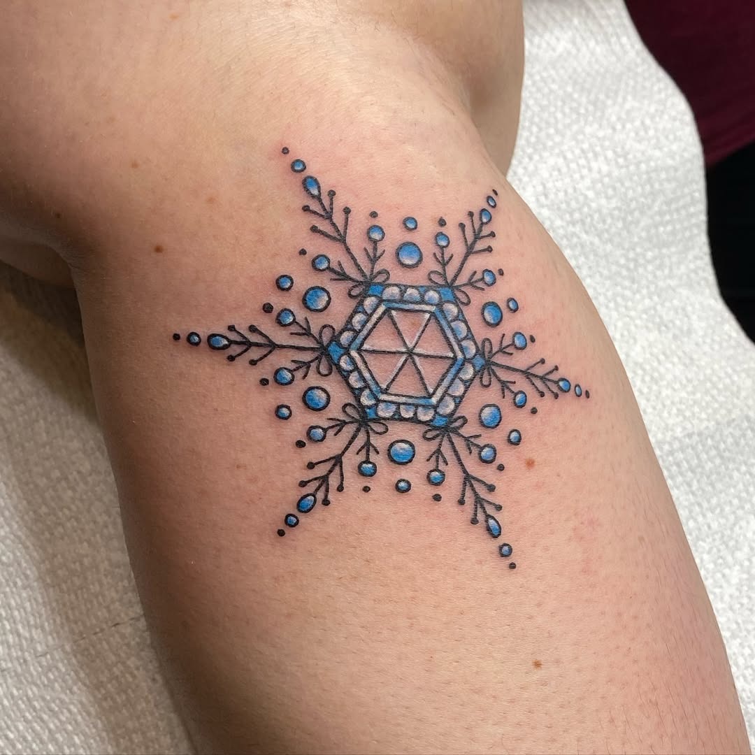Intricate blue snowflake tattoo design on arm Tattoo Design