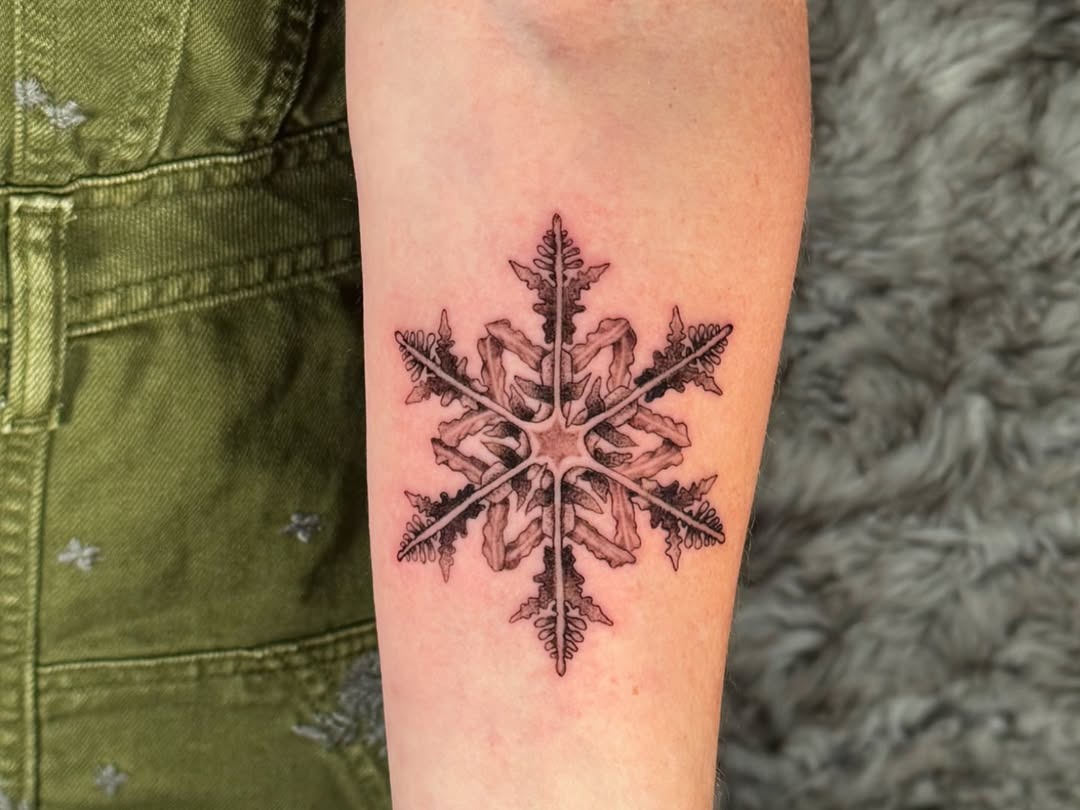 Intricate snowflake tattoo with delicate details Tattoo Design