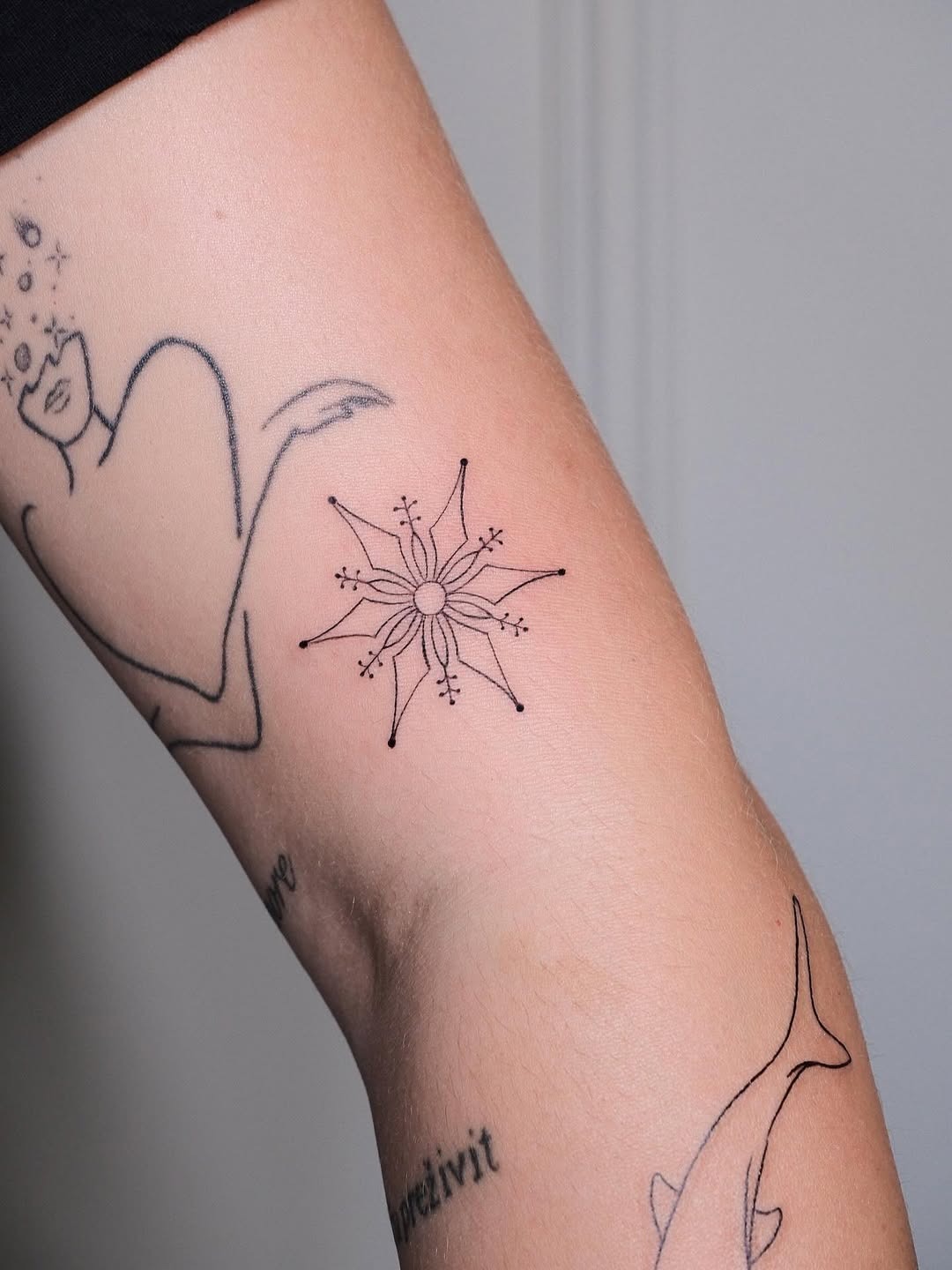 Minimalist snowflake tattoo showcases elegant design Tattoo Design