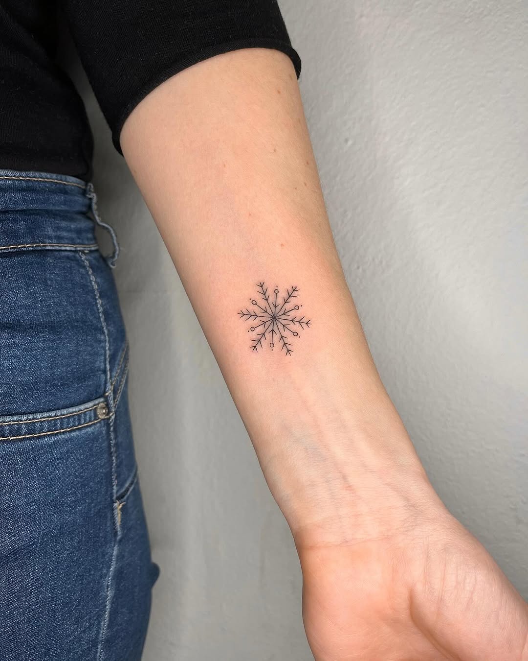 Minimalist snowflake tattoo with intricate details Tattoo Design