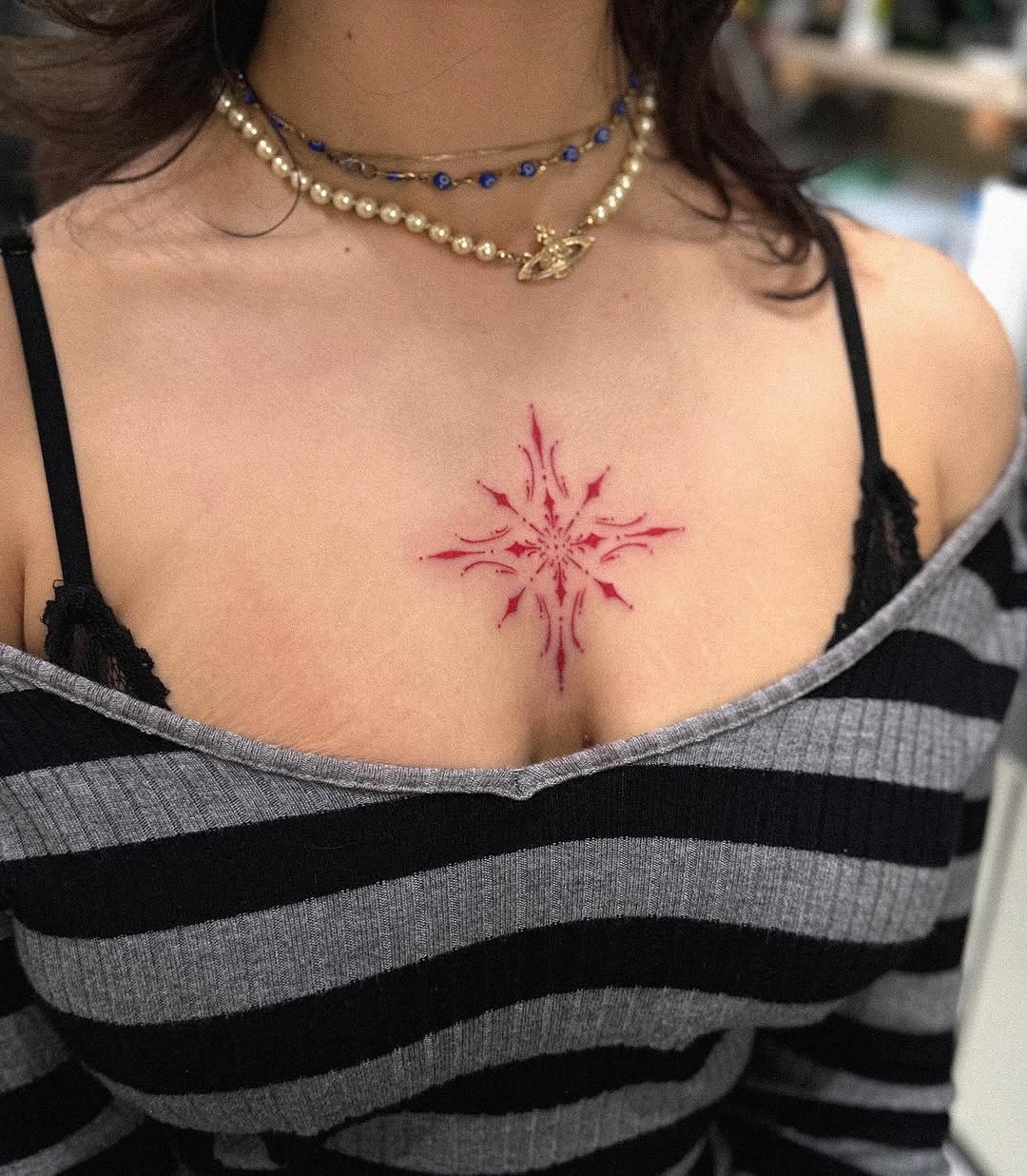 Unique Red Snowflake Tattoo on Chest Tattoo Design