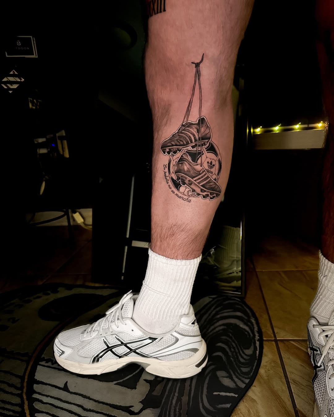 Creative soccer leg tattoo showcasing iconic footwear Tattoo Design