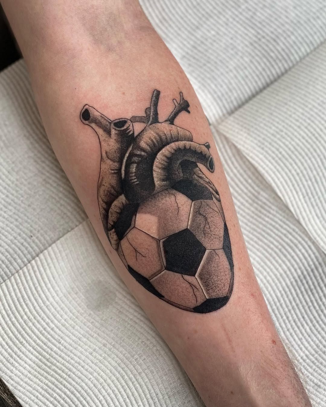 Heart and soccer ball intertwined in tattoo art Tattoo Design