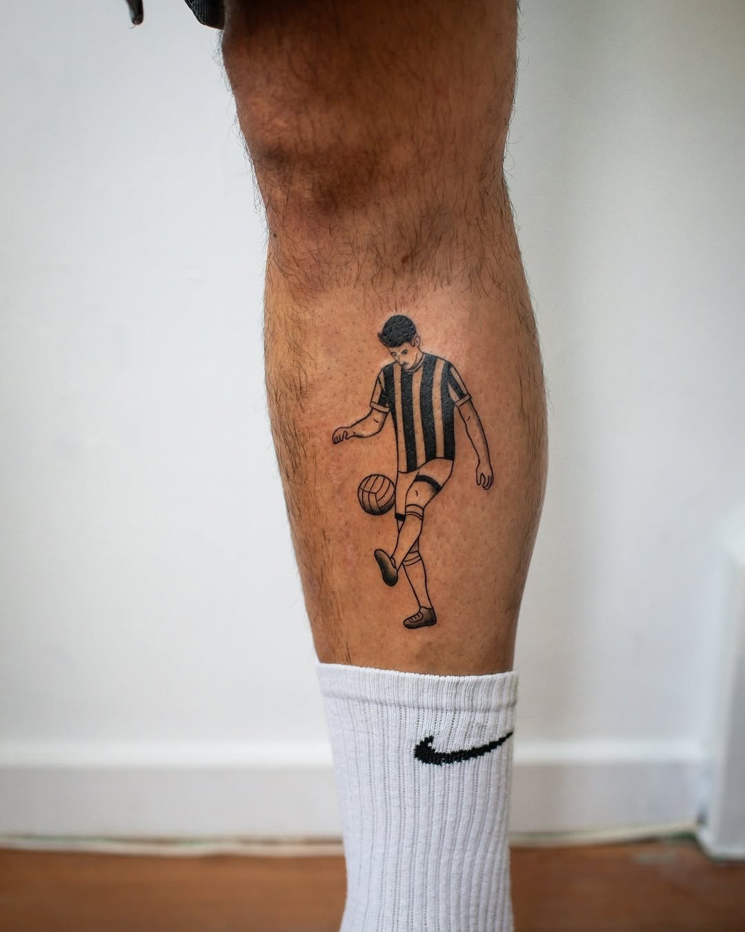 Stylized soccer player tattoo on the leg Tattoo Design