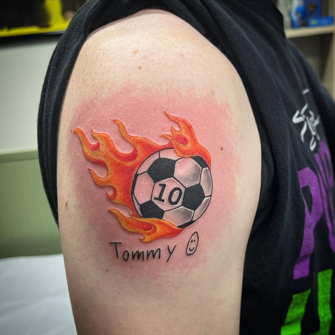 Vibrant flames enhance soccer tattoo design Tattoo Design