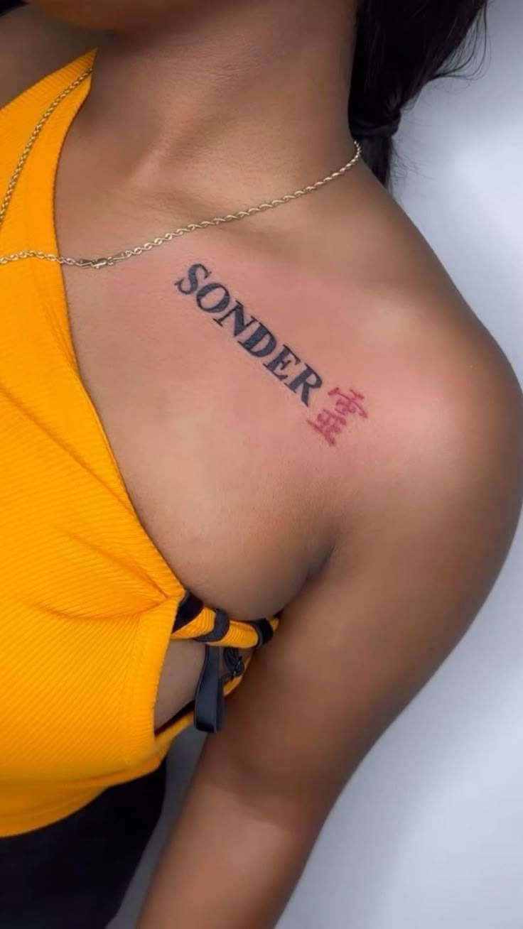 Chest Placement Sonder with Red Symbol Accent Tattoo Design