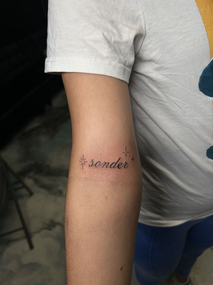 Delicate Sonder with Star Accents Tattoo Design