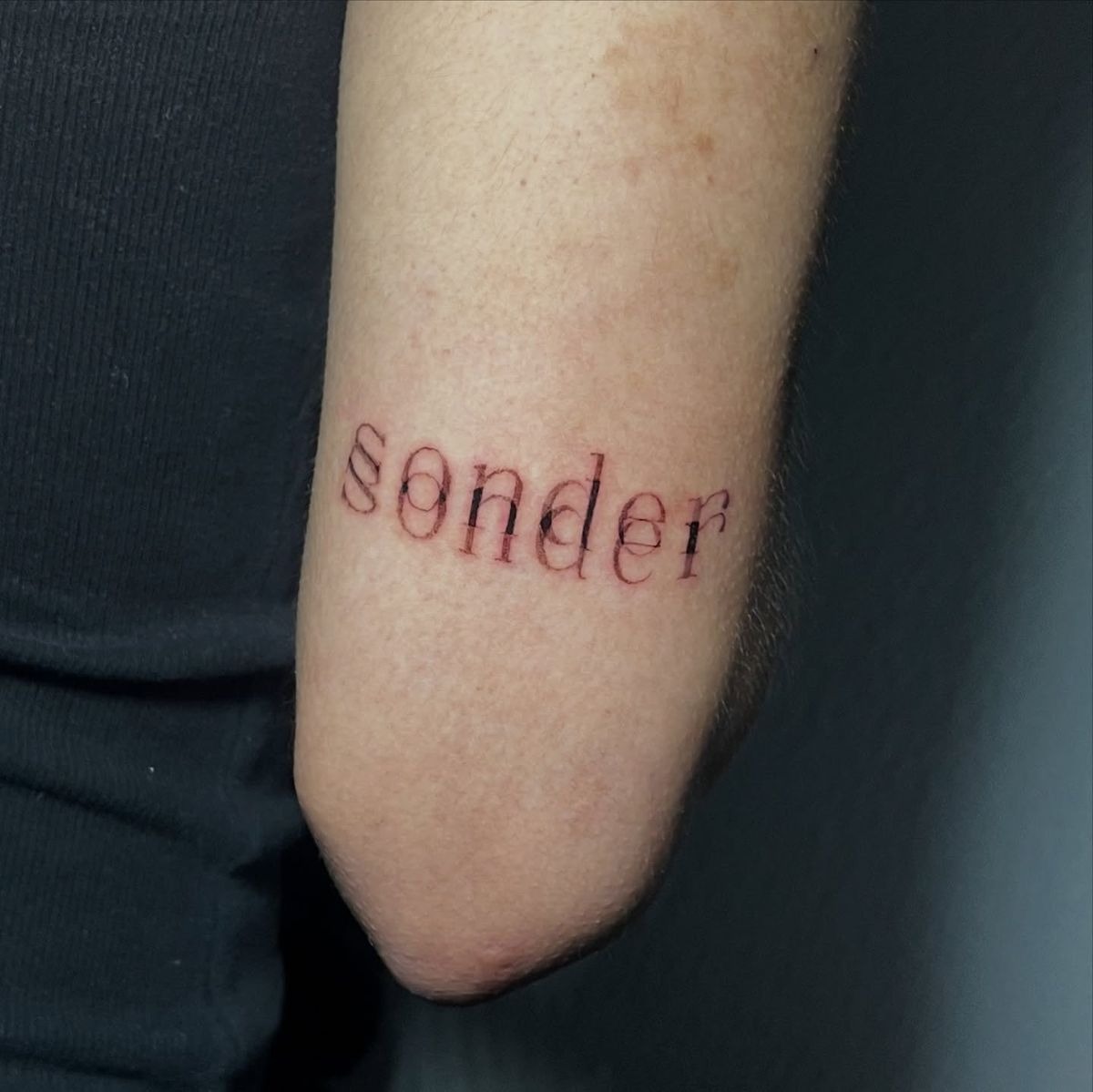 Soft Red Sonder Elbow Placement Tattoo Design