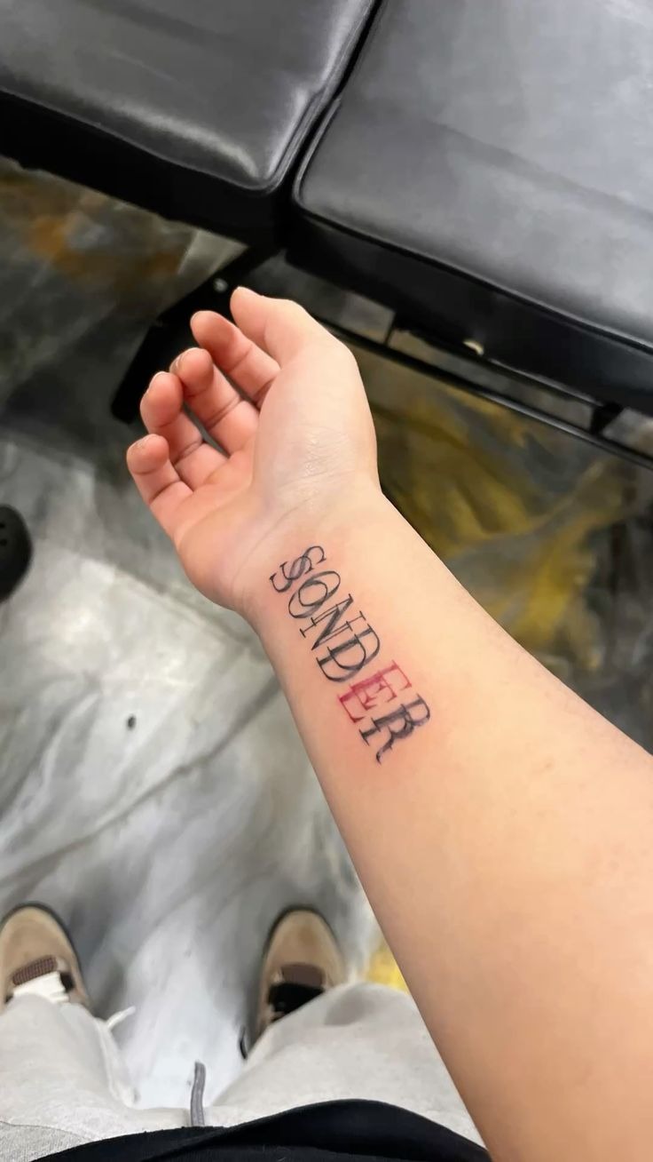 Sonder Wrist Statement with Red Accent Tattoo Design