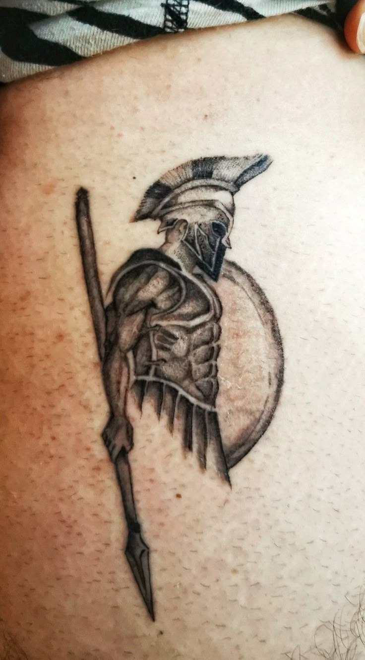 Minimal Spartan Silhouette, a tattoo design rendered in clean detailed linework for the hand.