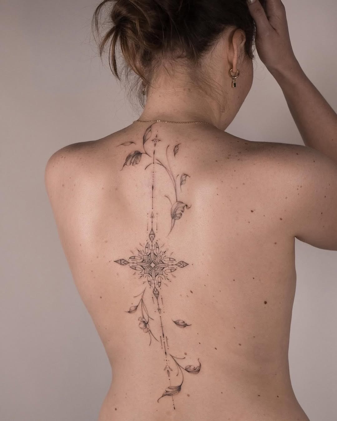 Delicate floral spine tattoo design with elegance Tattoo Design