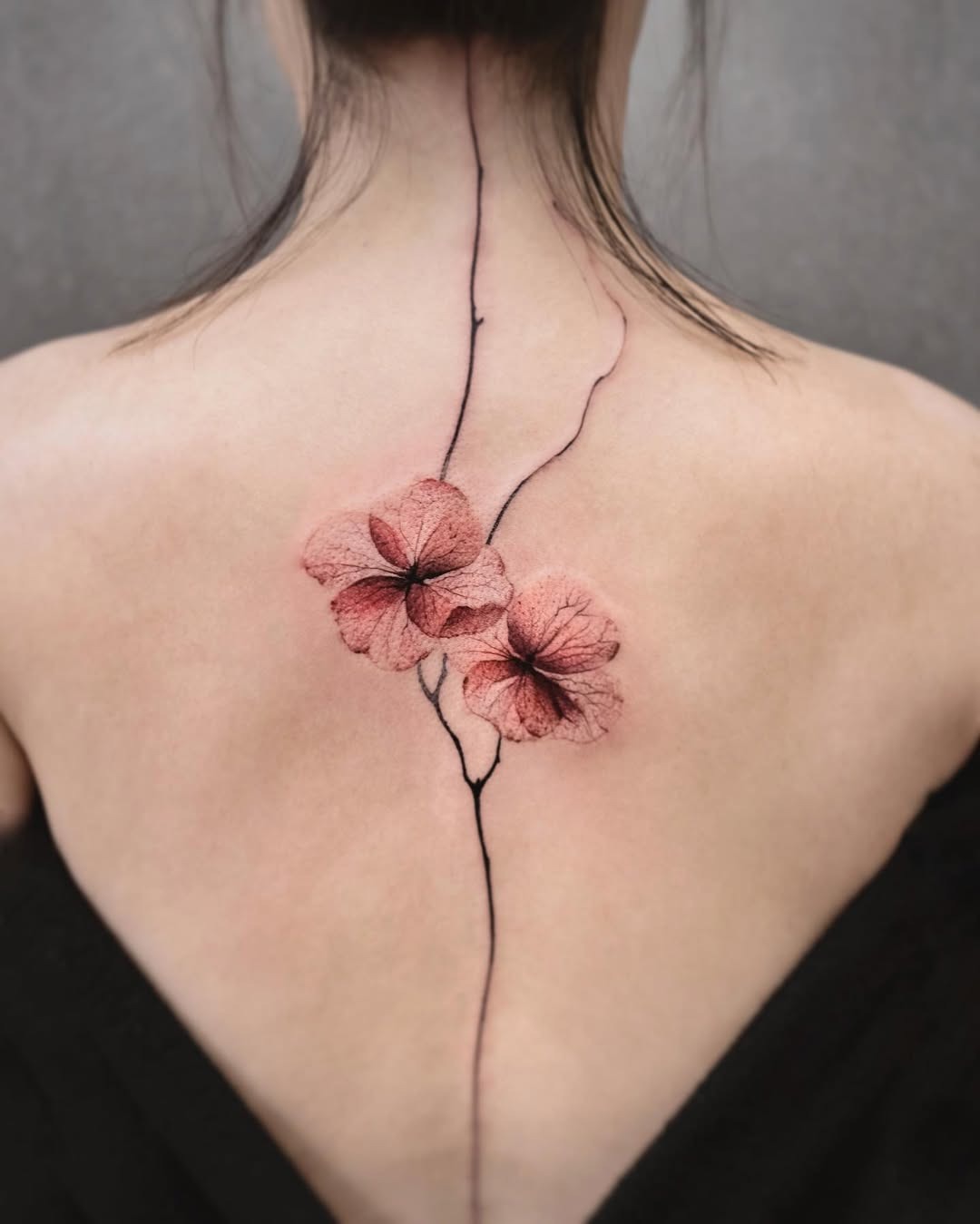 Delicate pink blossoms along the spine Tattoo Design