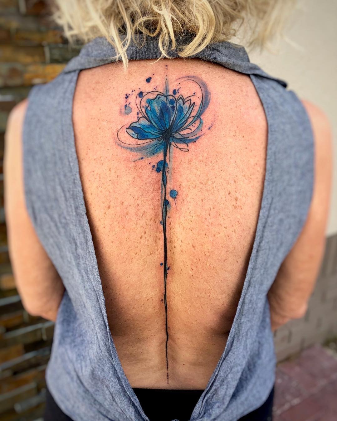 Elegant blue flower spine tattoo design Tattoo Design
