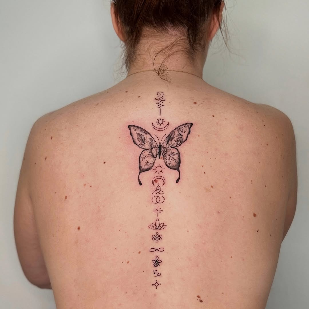 Elegant butterfly spine tattoo with symbolic details Tattoo Design