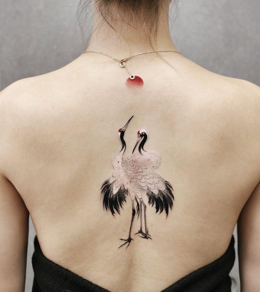 Elegant cranes adorned on the spine region Tattoo Design