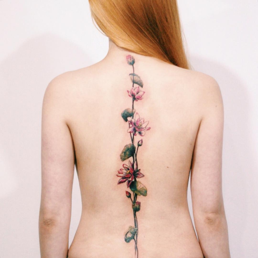 Elegant floral spine tattoo showcasing beauty and symmetry Tattoo Design