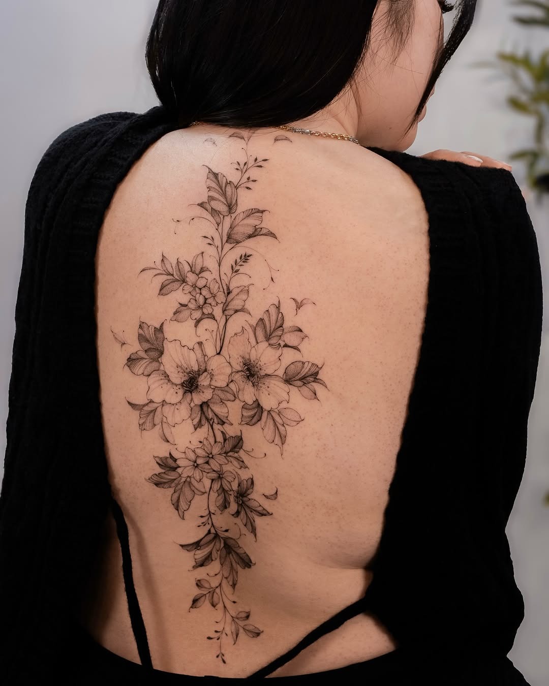 Exquisite floral spine tattoo with intricate detailing Tattoo Design