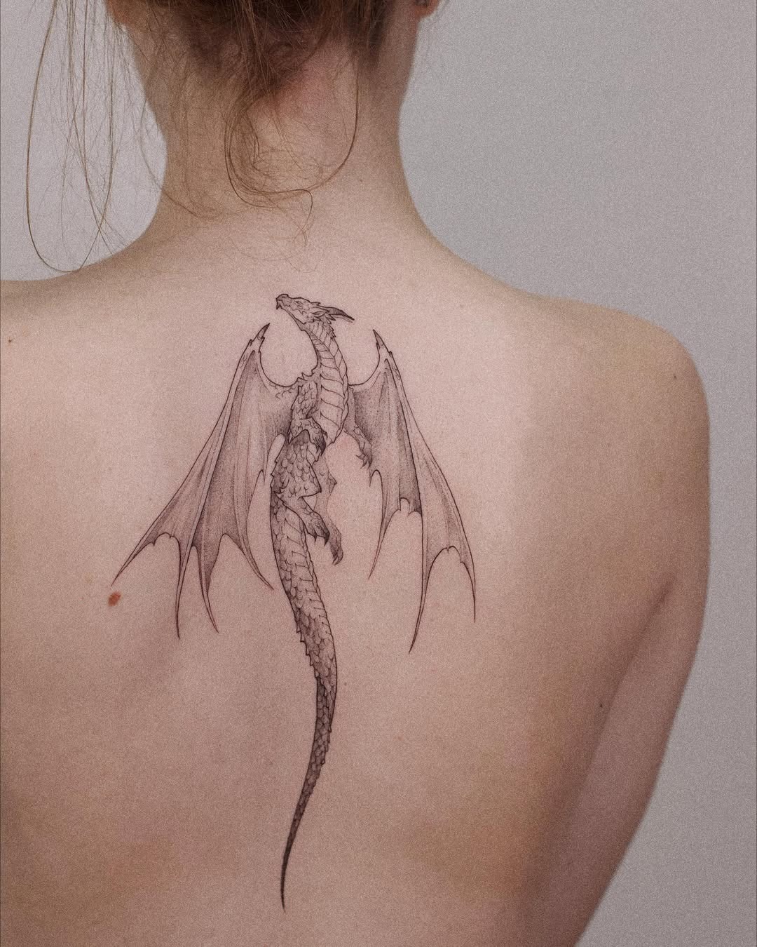 Intricate dragon tattoo scales along the spine Tattoo Design