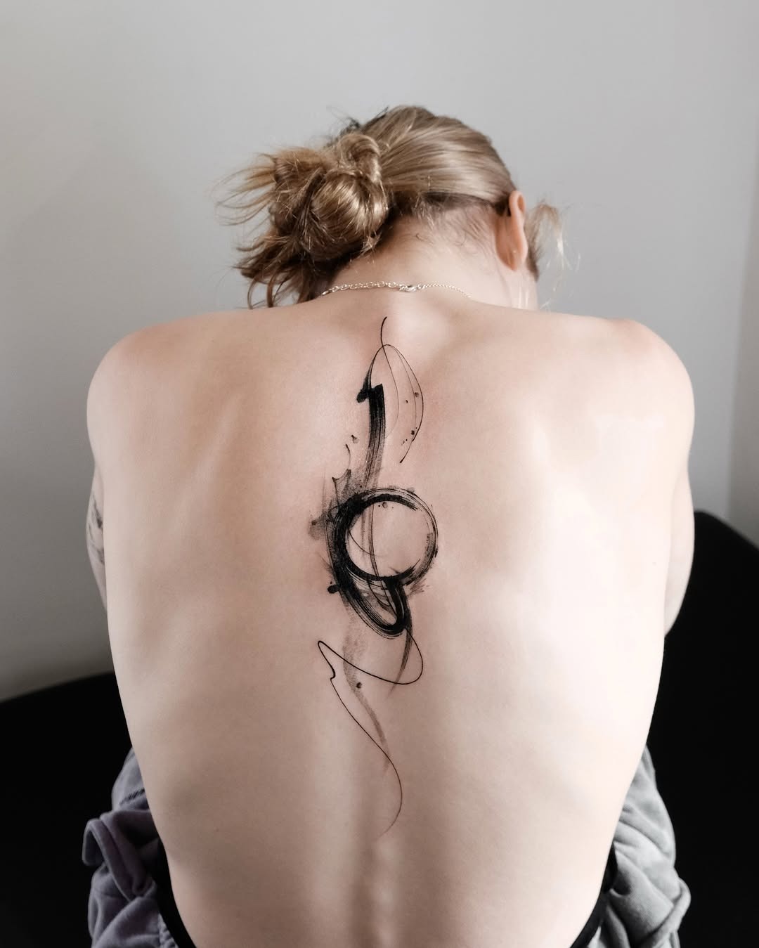 Sleek minimalist spine tattoo with abstract design Tattoo Design