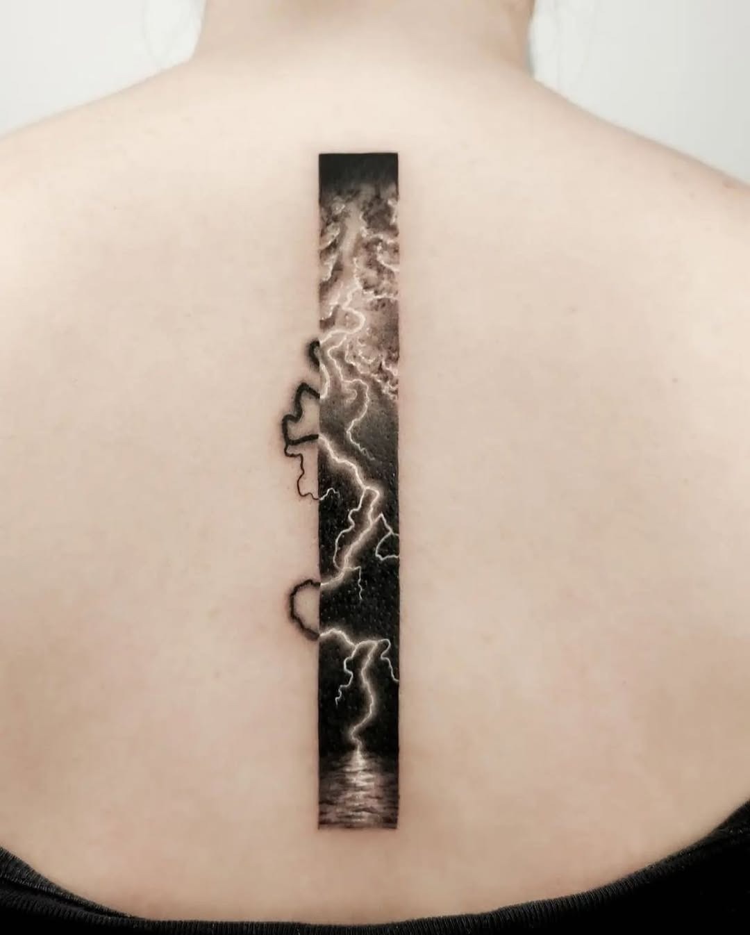 Striking Lightning Tattoo Along the Spine Tattoo Design