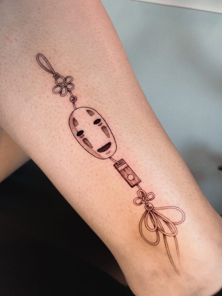 Elegant No-Face Tattoo with Floral Accents Tattoo Design