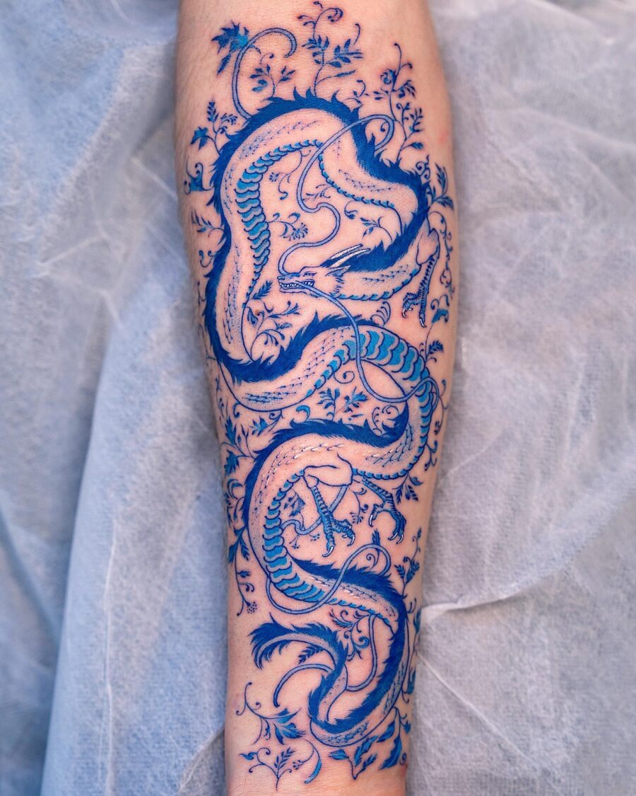 Intricate blue dragon tattoo with floral details Tattoo Design