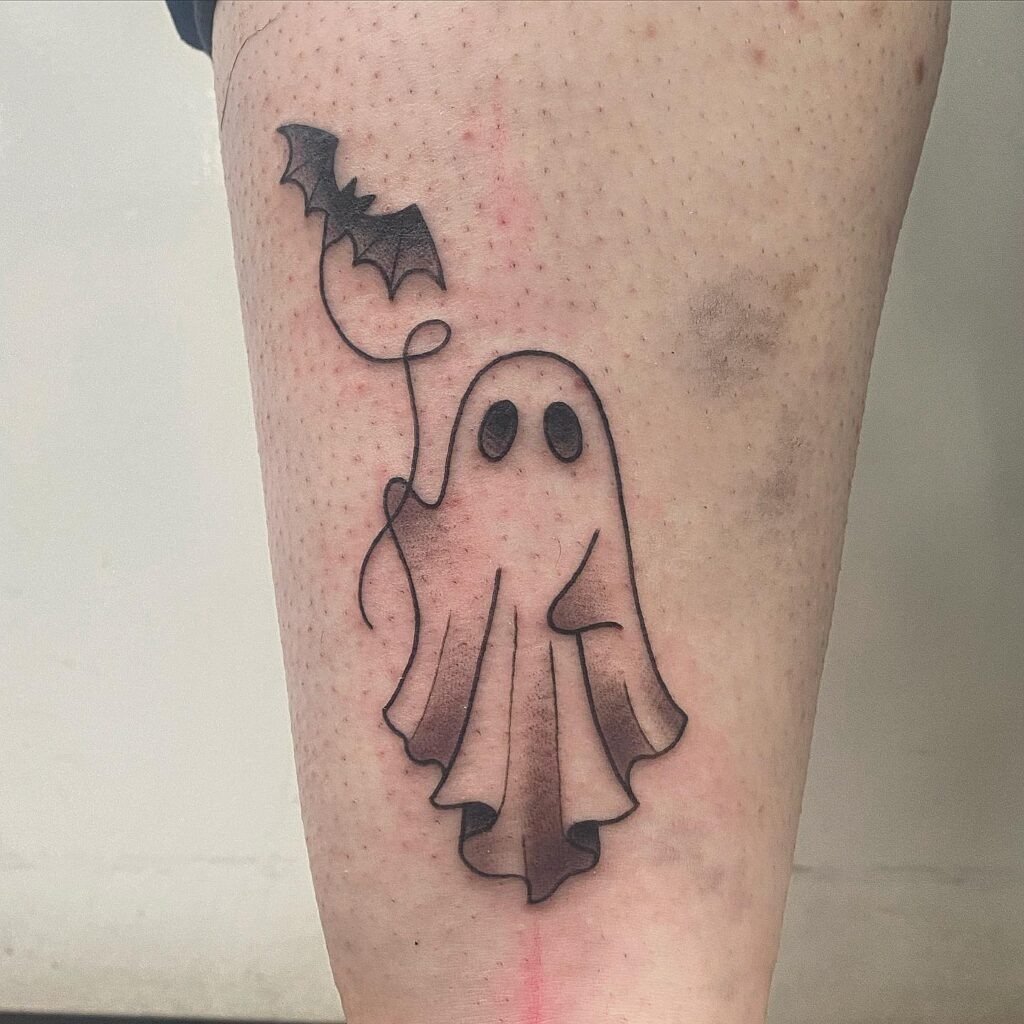 Playful Ghost with Bat Balloon Tattoo Tattoo Design