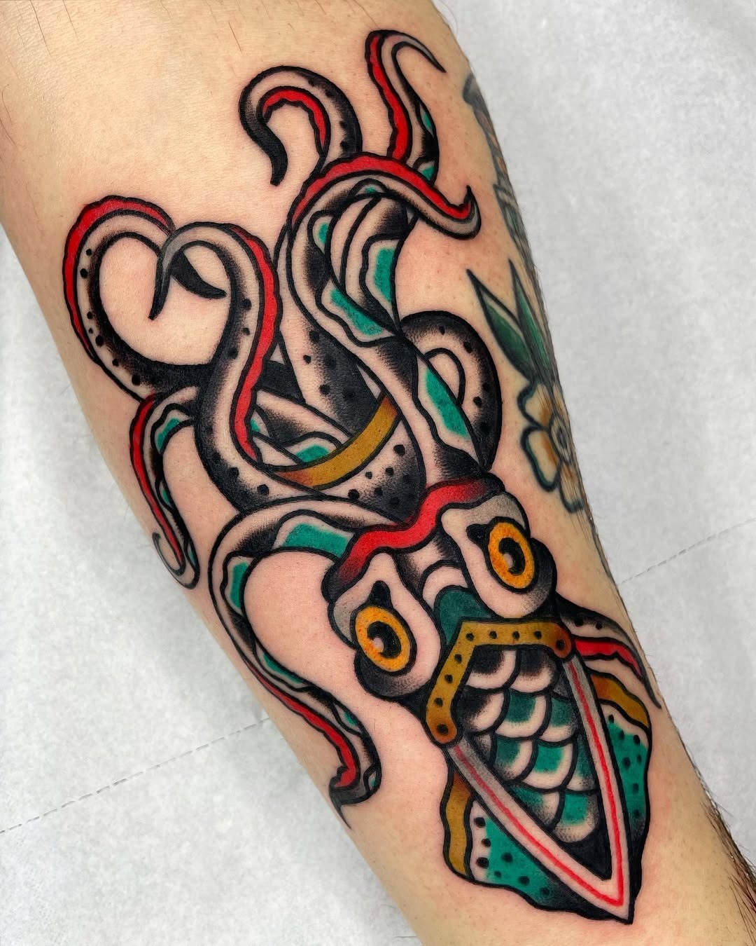 Bold squid tattoo with vibrant colors and details Tattoo Design