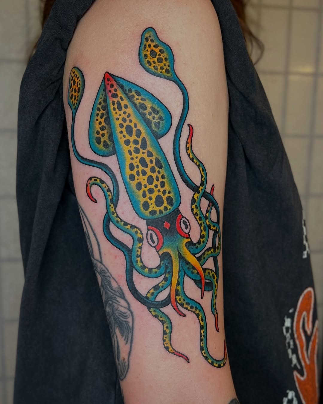 Colorful squid tattoo reflects oceanic vibes. Tattoo Design
