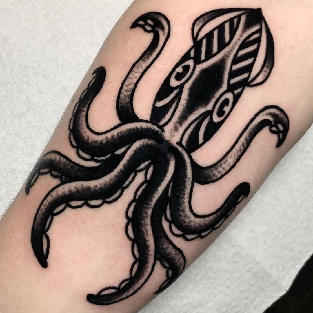 Intricate black squid tattoo design on arm Tattoo Design