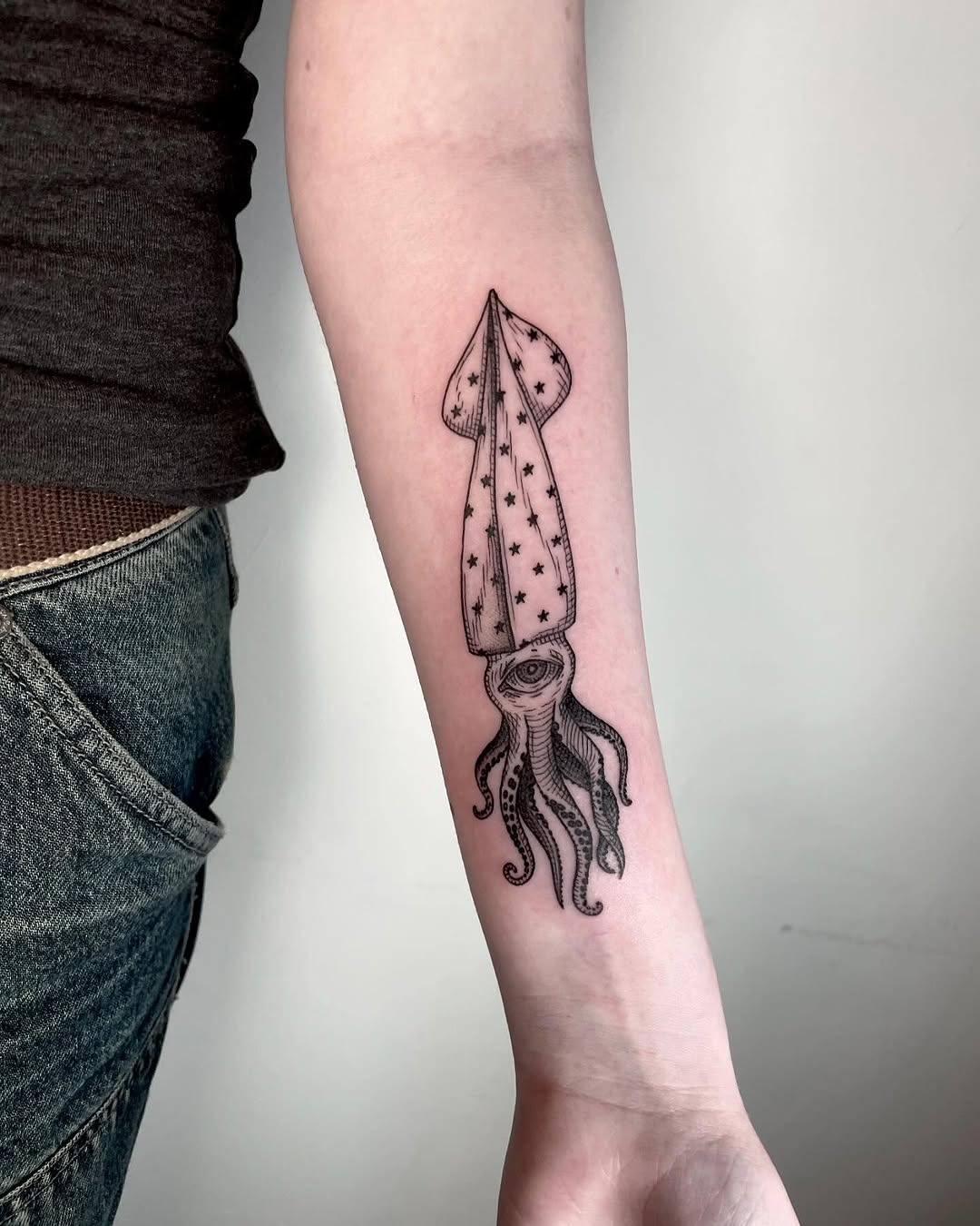 Starlit squid tattoo on forearm Tattoo Design